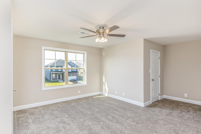 spare room with visible vents, ceiling fan, baseboards, and carpet floors