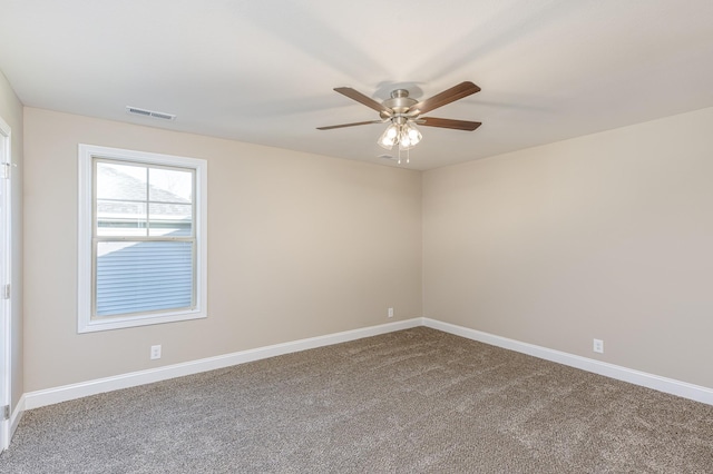 spare room featuring baseboards, carpet floors, visible vents, and ceiling fan