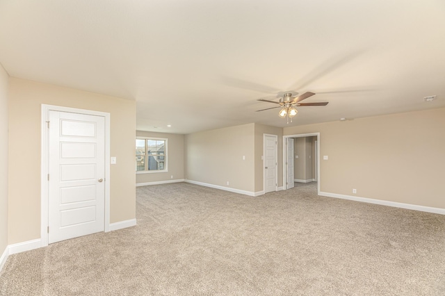 unfurnished room featuring ceiling fan, baseboards, and carpet