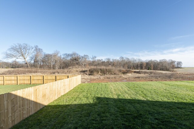 view of yard featuring a rural view and fence