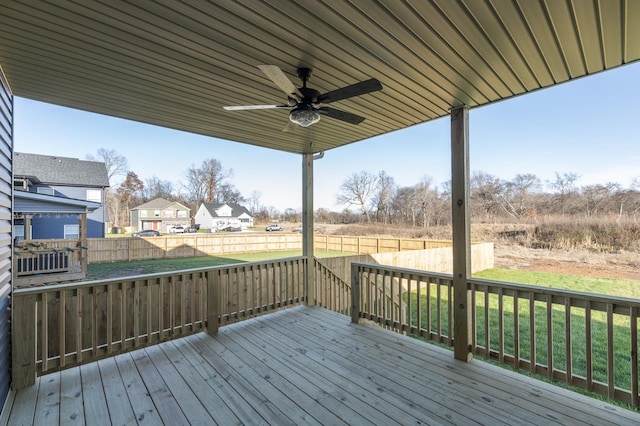 wooden deck with a lawn, ceiling fan, and fence