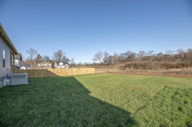 view of yard with cooling unit and fence