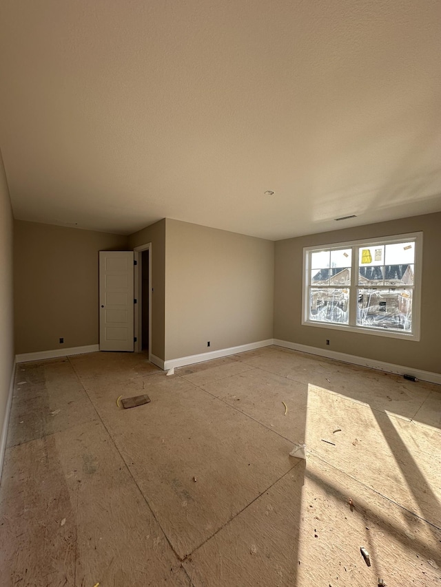 empty room featuring baseboards