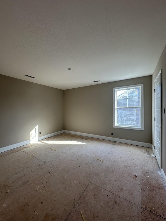 unfurnished room featuring baseboards