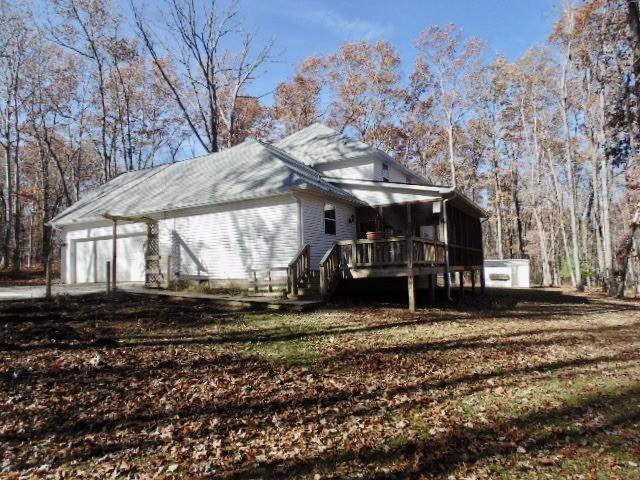 view of property exterior featuring a wooden deck