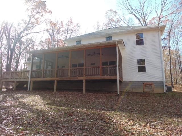 rear view of house featuring a sunroom and central AC unit