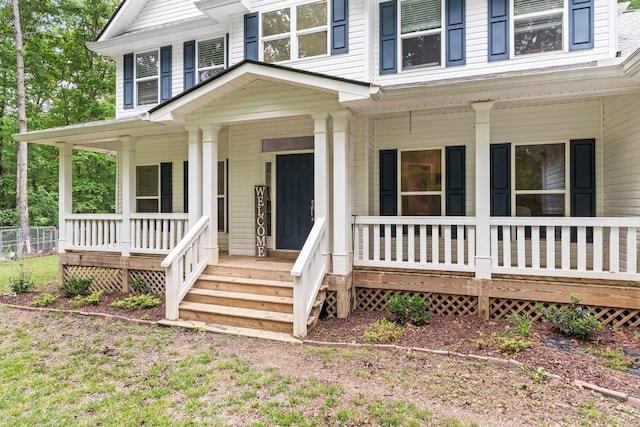 view of exterior entry featuring a porch