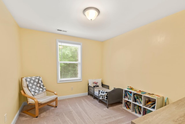 living area featuring light carpet