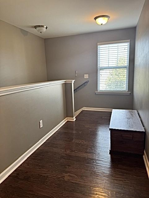 spare room featuring dark hardwood / wood-style floors