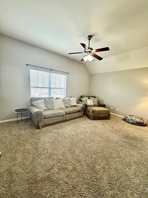 unfurnished living room featuring carpet flooring, ceiling fan, and lofted ceiling