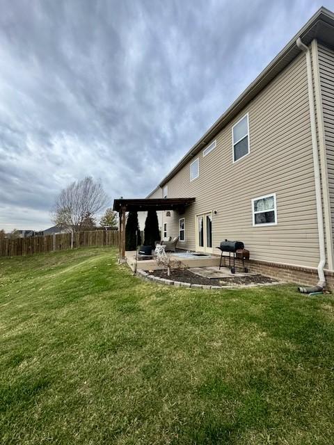 rear view of property with a patio area and a yard