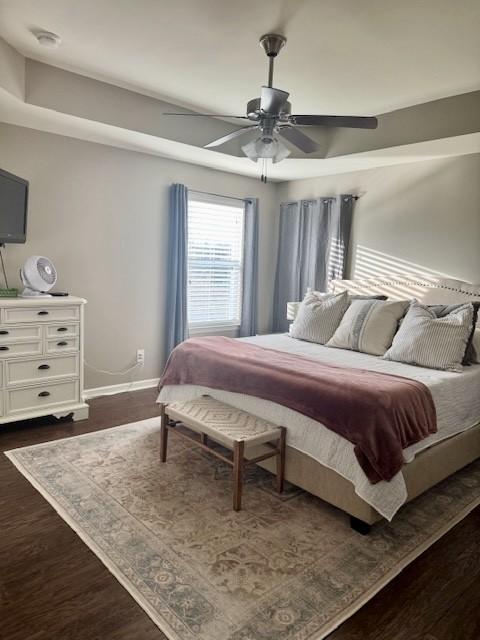 bedroom with ceiling fan and dark wood-type flooring