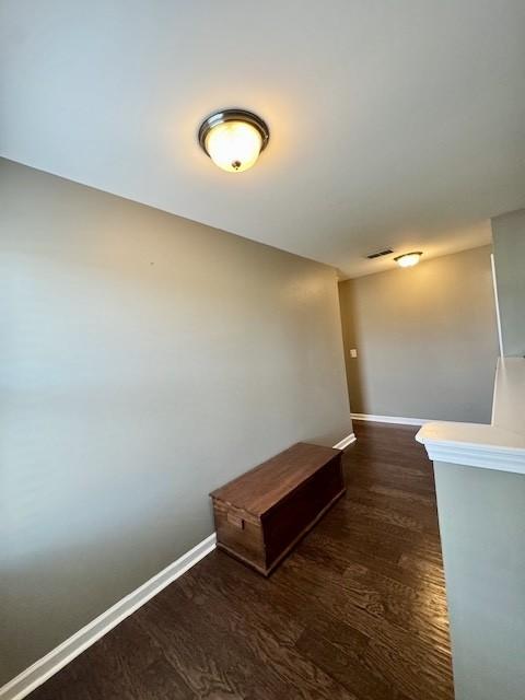 corridor featuring dark hardwood / wood-style flooring