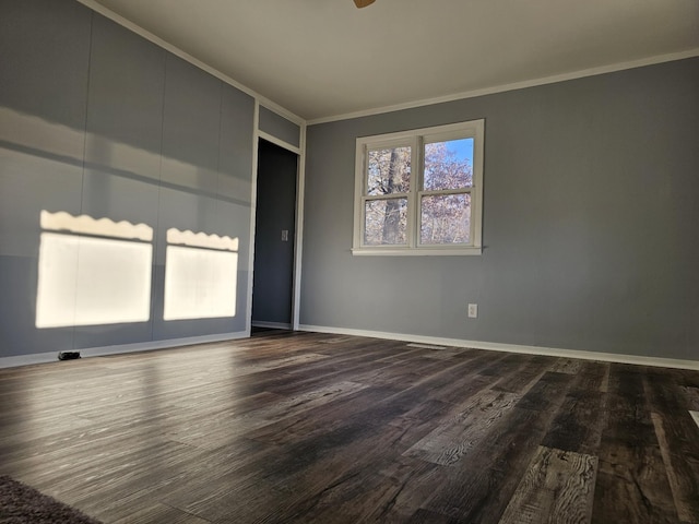 unfurnished room featuring crown molding and dark hardwood / wood-style flooring