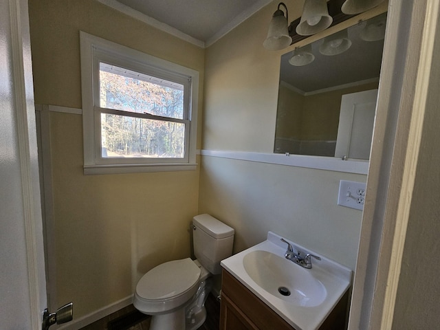 bathroom with vanity, toilet, and crown molding