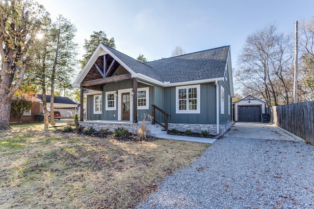 view of front facade with a porch, a garage, and an outdoor structure