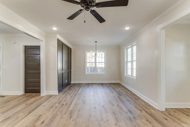 unfurnished dining area with crown molding, light hardwood / wood-style flooring, and ceiling fan with notable chandelier