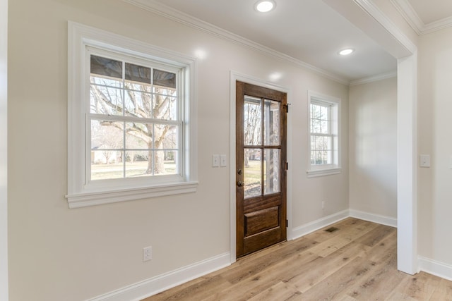 entryway with crown molding and light hardwood / wood-style flooring