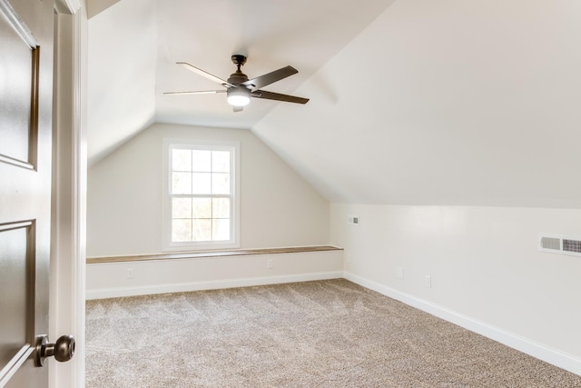 additional living space featuring light carpet, vaulted ceiling, and ceiling fan