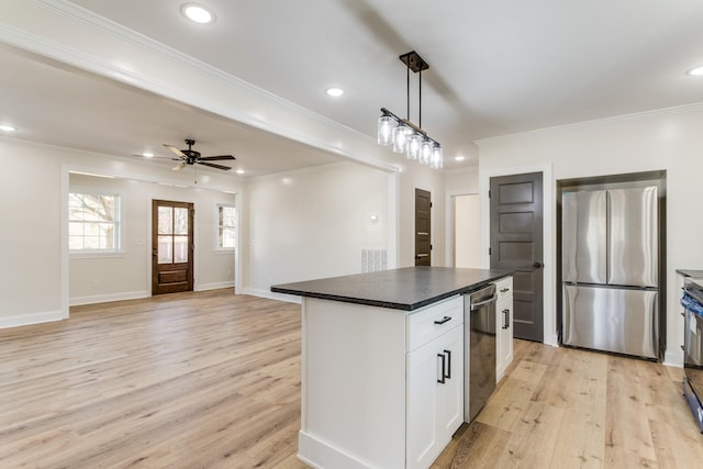 kitchen featuring stainless steel fridge, a kitchen island, light hardwood / wood-style flooring, white cabinetry, and hanging light fixtures