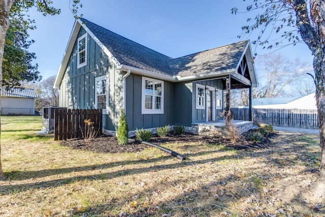 view of property exterior featuring central AC unit and a lawn