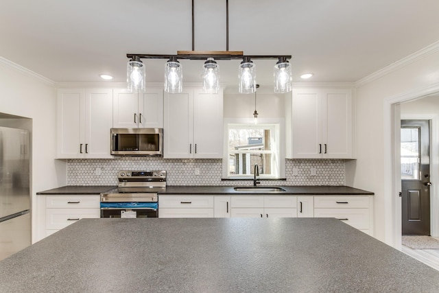 kitchen featuring white cabinets, plenty of natural light, sink, and stainless steel appliances