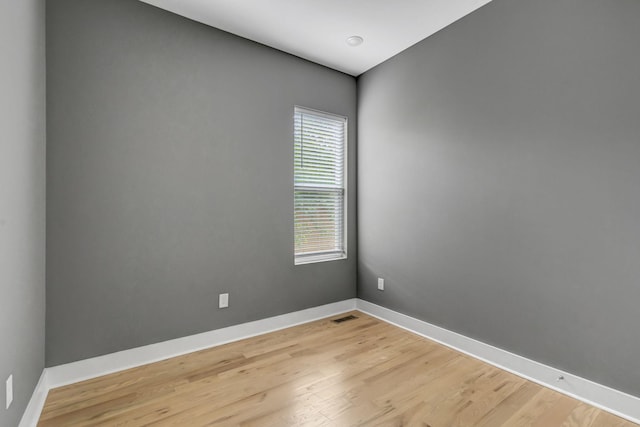 empty room with light hardwood / wood-style flooring