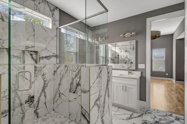 bathroom with vanity and a shower with door