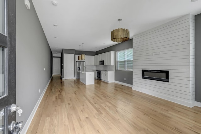 unfurnished living room featuring light hardwood / wood-style floors