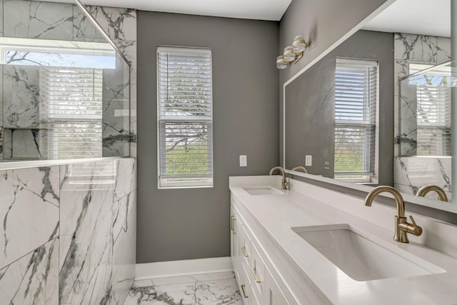 bathroom with a wealth of natural light, vanity, and an enclosed shower