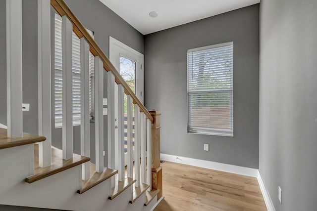 staircase with hardwood / wood-style floors