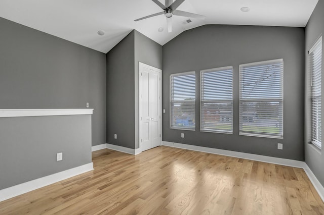 empty room featuring light hardwood / wood-style flooring, ceiling fan, and lofted ceiling