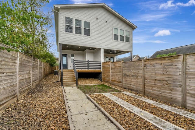 back of house featuring a deck