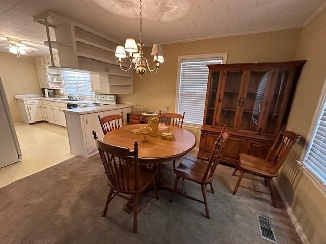1487 Natchez Trace Rd, Camden, TN 38320 - dining area with a chandelier, ornamental molding, ceiling fan, and light colored carpet