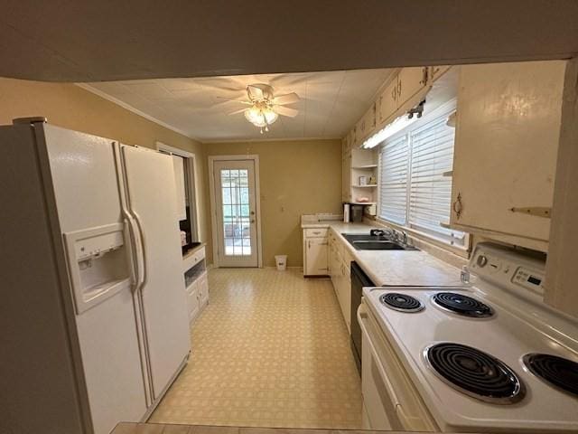 kitchen featuring white appliances, white cabinetry, ceiling fan, and sink