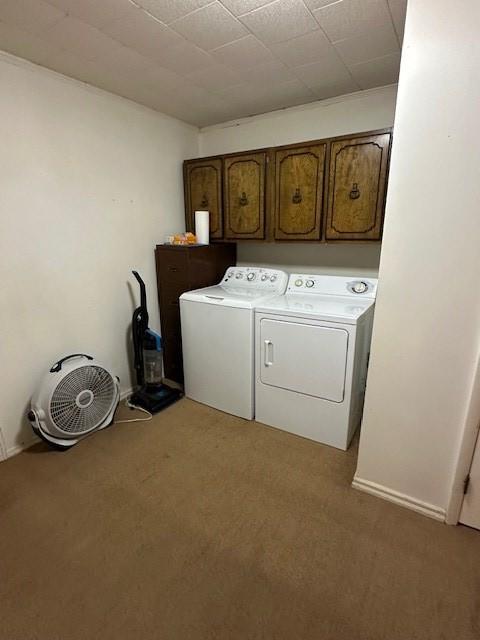 1487 Natchez Trace Rd, Camden, TN 38320 - laundry area with cabinet space, washer and clothes dryer, and light colored carpet