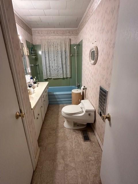 full bathroom with vanity, toilet, ornamental molding, shower / bath combination, and heating unit