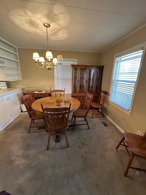 1487 Natchez Trace Rd, Camden, TN 38320 - carpeted dining area featuring a chandelier and ornamental molding