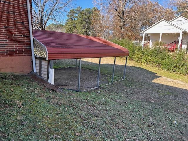 exterior space with a yard and a carport