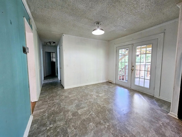 spare room featuring crown molding, french doors, and a textured ceiling