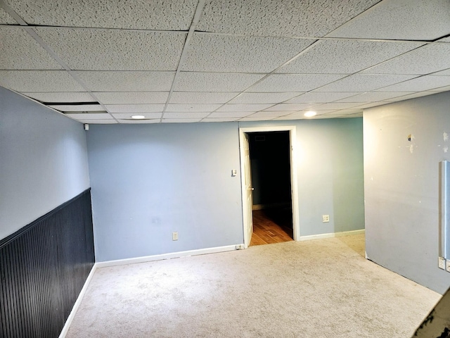 basement with carpet flooring and a paneled ceiling