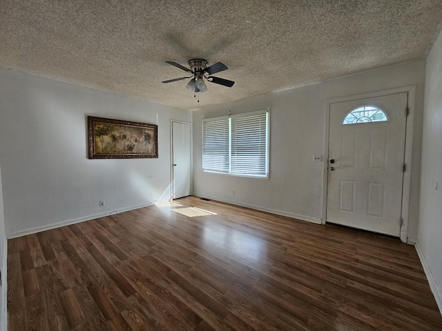 foyer with dark hardwood / wood-style floors, ceiling fan, and a textured ceiling