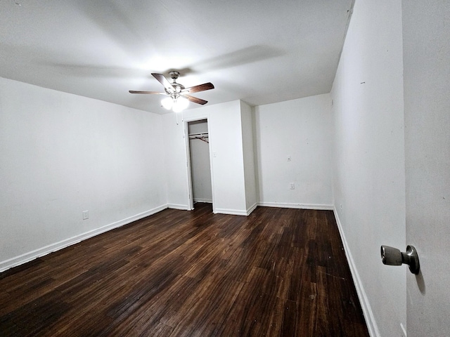 unfurnished bedroom featuring ceiling fan, dark hardwood / wood-style flooring, and a closet