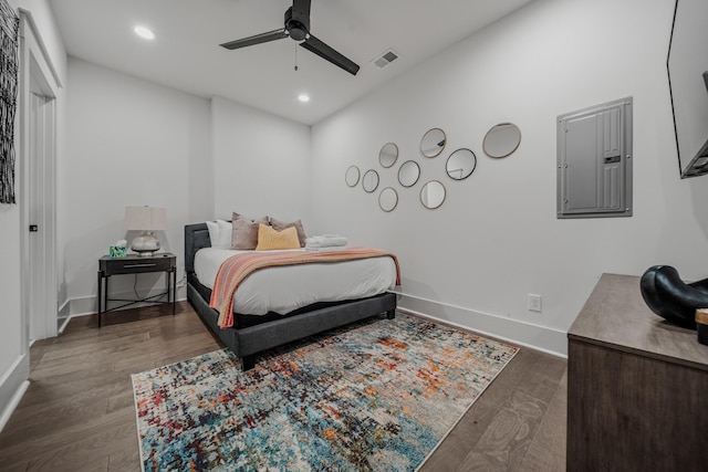 bedroom featuring electric panel, dark hardwood / wood-style floors, and ceiling fan