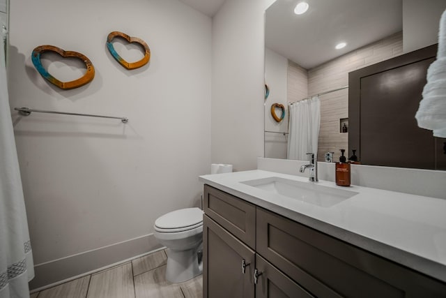 bathroom featuring vanity, curtained shower, and toilet