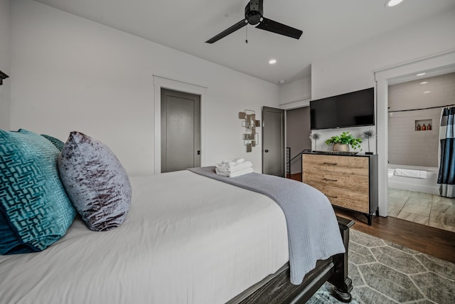 bedroom featuring ceiling fan, dark hardwood / wood-style floors, and connected bathroom