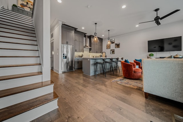 living room featuring ceiling fan and dark hardwood / wood-style flooring