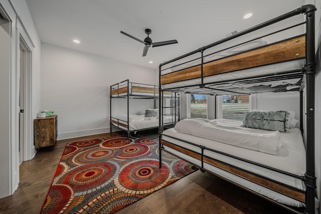 bedroom with dark hardwood / wood-style floors and ceiling fan