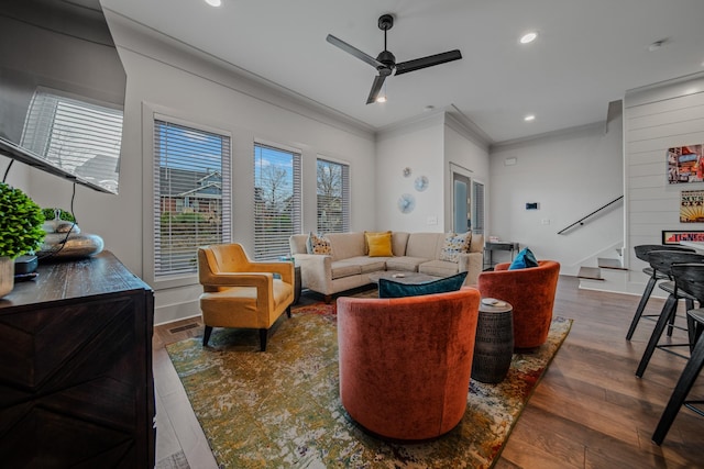 living room featuring ceiling fan, dark hardwood / wood-style flooring, and ornamental molding