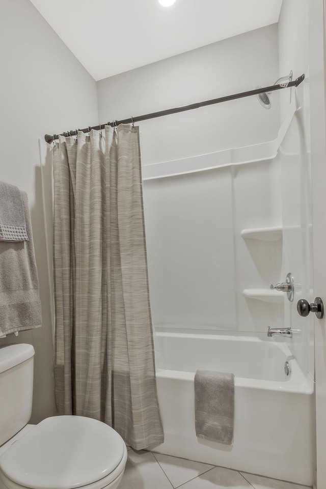 bathroom with tile patterned flooring, toilet, and shower / tub combo